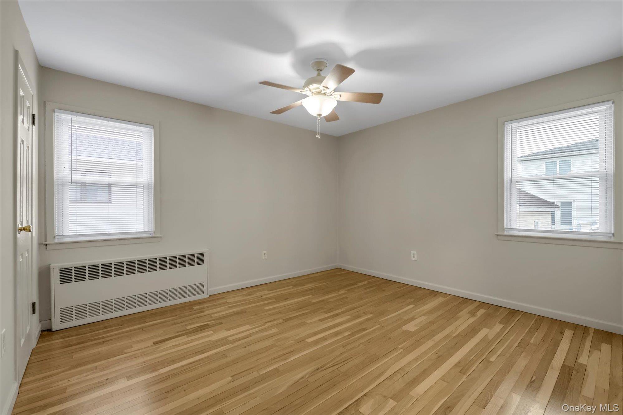 9 Graywood Road Port Washington, NY 11050 - Photo 9 of 23 wooden floor in an empty room with a window
