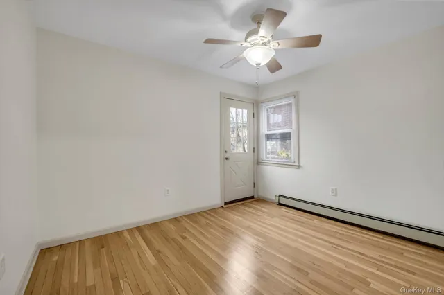 wooden floor in an empty room with a window