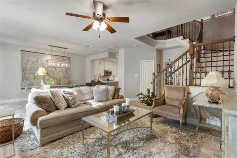 a living room with furniture ceiling fan and a rug