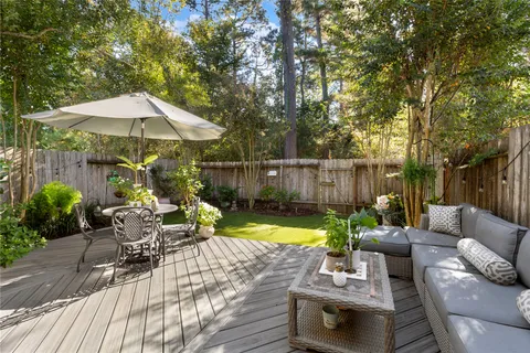 a view of backyard with seating space and trees