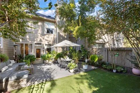 a view of a patio with table and chairs under an umbrella