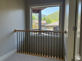 514 North Olympic Way Midway, UT 84049 - Photo 15 of 30 Interior landing with a wood handrail and black metal balusters with view of Master Bedroom Private Deck