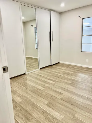 a view of kitchen with granite countertop cabinets and sink
