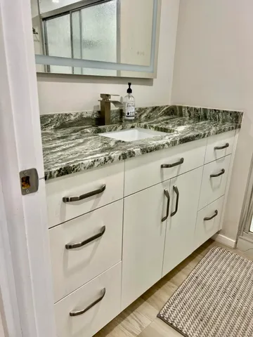 a bathroom with a glass shower door