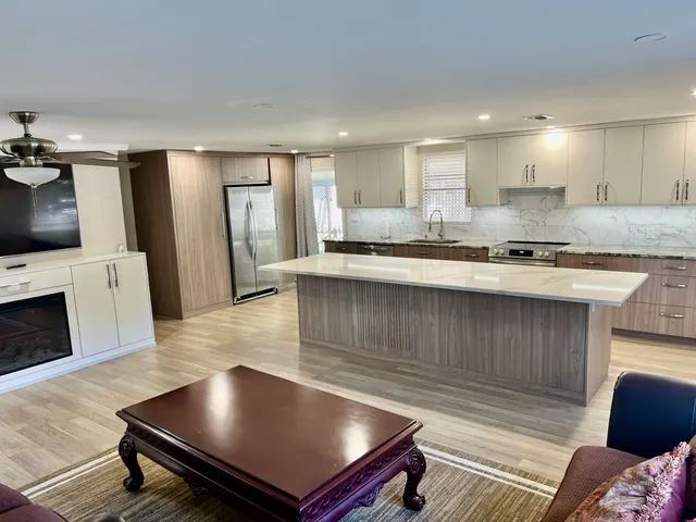 an empty room with wooden floor and window
