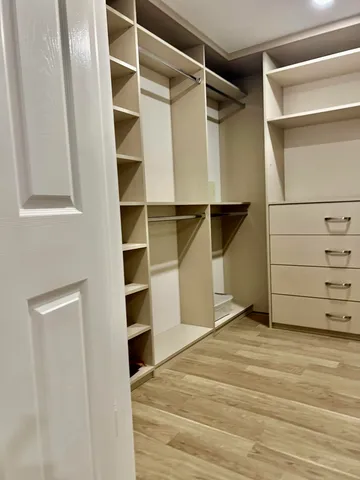 a view of walk in closet with empty racks
