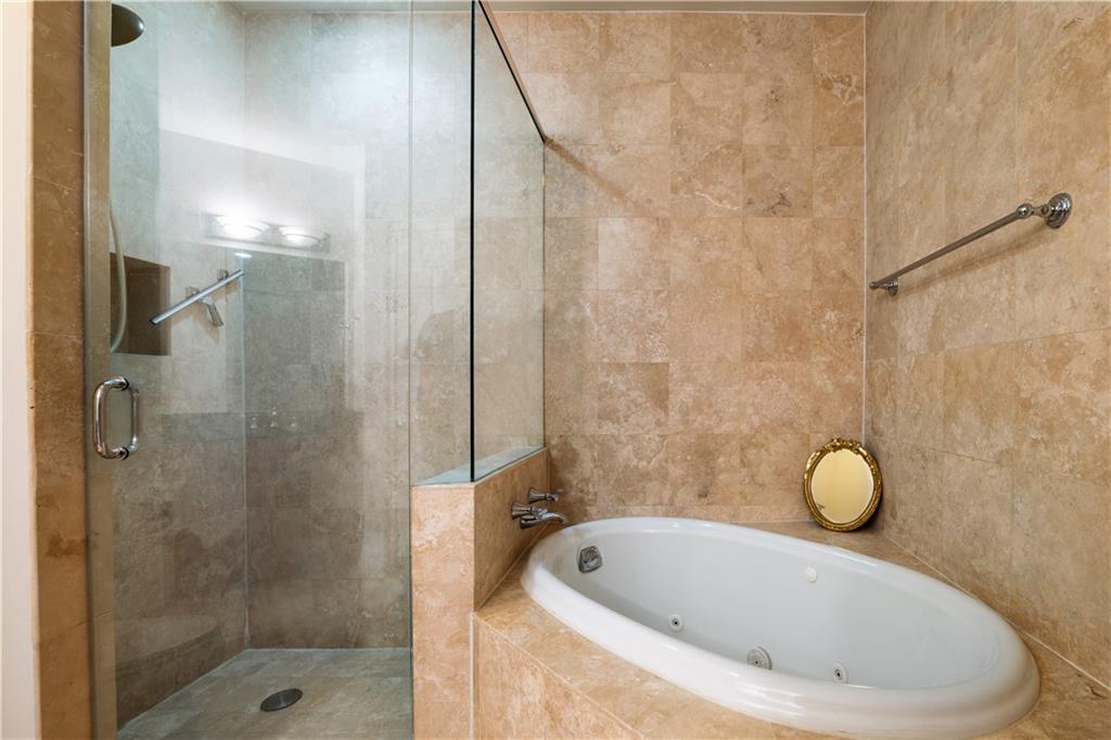 2828 Peachtree Road Northwest, Unit 1501 Atlanta, GA 30305 - Photo 14 of 30 a bathroom with a tub sink and shower
