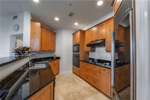a kitchen with stainless steel appliances granite countertop a stove and a microwave
