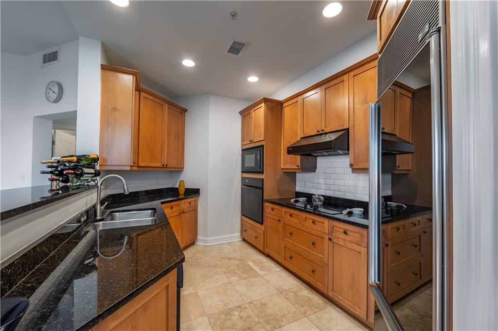 2828 Peachtree Road Northwest, Unit 1501 Atlanta, GA 30305 - Photo 2 of 30 a kitchen with stainless steel appliances granite countertop a stove and a microwave