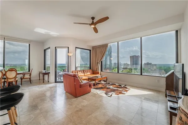 a living room with furniture and a floor to ceiling window