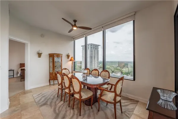a dining room with furniture and window