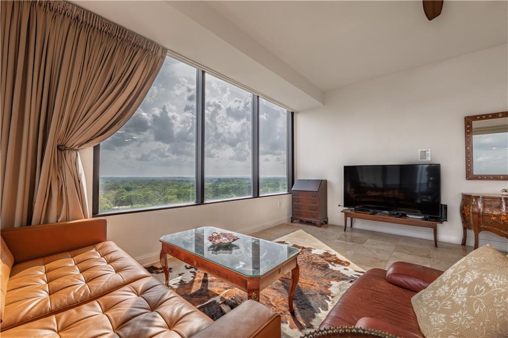 2828 Peachtree Road Northwest, Unit 1501 Atlanta, GA 30305 - Photo 6 of 30 a living room with a large window and a flat screen tv