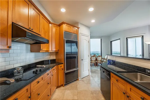 a kitchen with stainless steel appliances granite countertop a stove and a sink