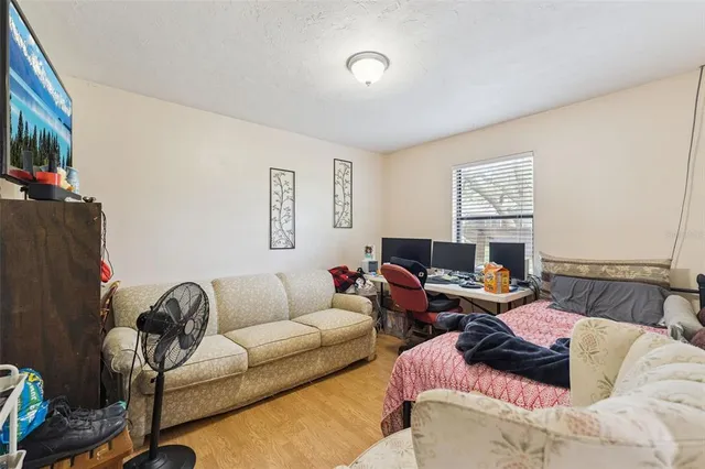 a living room with lots of furniture and a large window