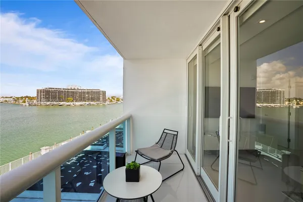 a balcony with table and chairs