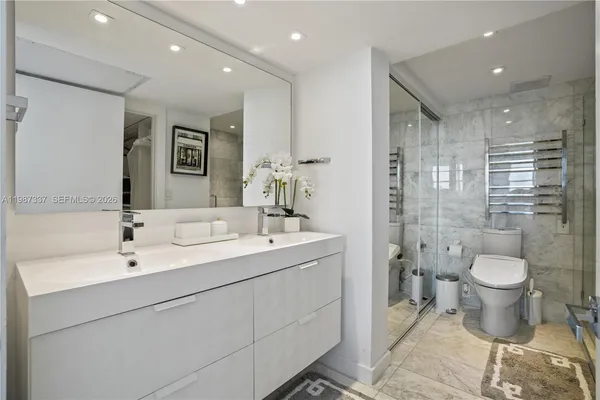a bathroom with a toilet sink and shower