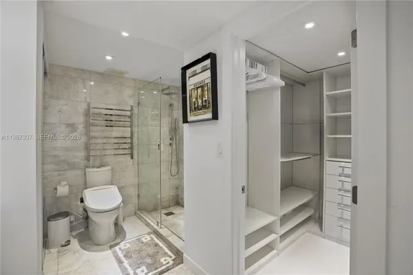 a bathroom with a toilet and a shower