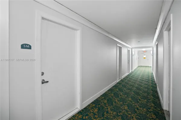 a view of a yard from a corridor