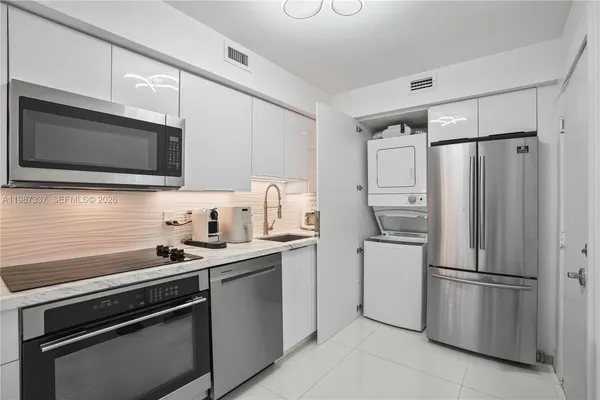 a kitchen with stainless steel appliances a refrigerator stove and microwave