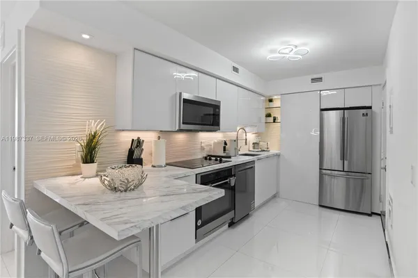 a kitchen with a stove a sink and a refrigerator