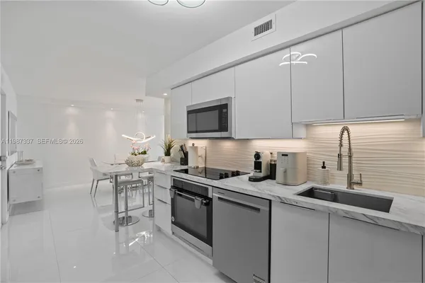 a kitchen with cabinets a sink and appliances