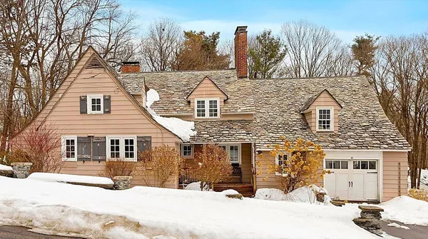 a view of a house with a yard covered in snow