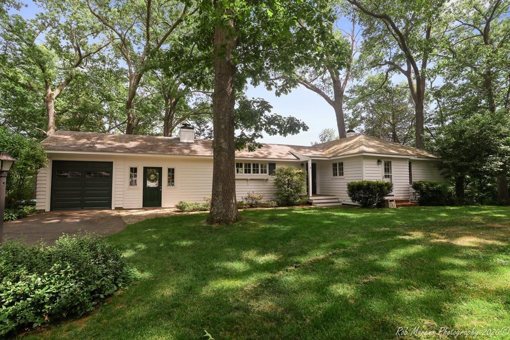 6 Pilgrim Road Hamilton, MA 01982 - Photo 32 of 32 a front view of a house with a yard and trees