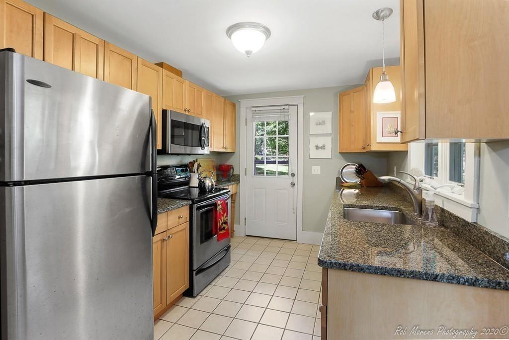 6 Pilgrim Road Hamilton, MA 01982 - Photo 4 of 32 a kitchen with stainless steel appliances granite countertop a refrigerator a stove a sink and a microwave
