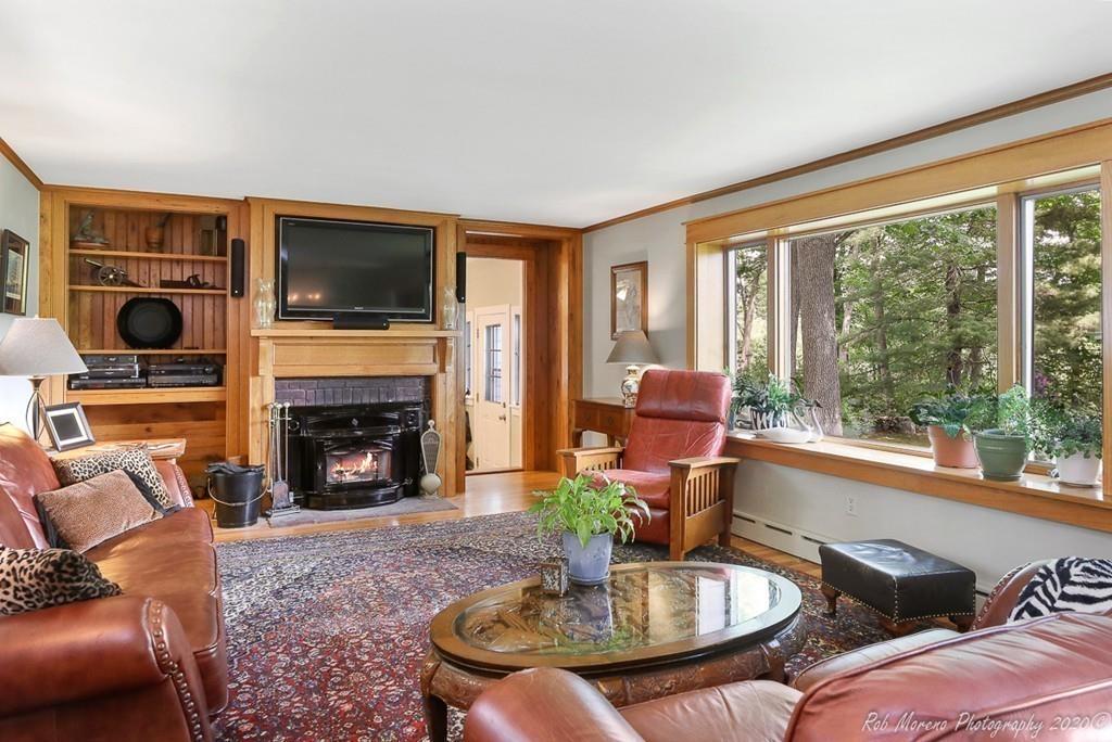 6 Pilgrim Road Hamilton, MA 01982 - Photo 7 of 32 a living room with furniture a flat screen tv and a fireplace