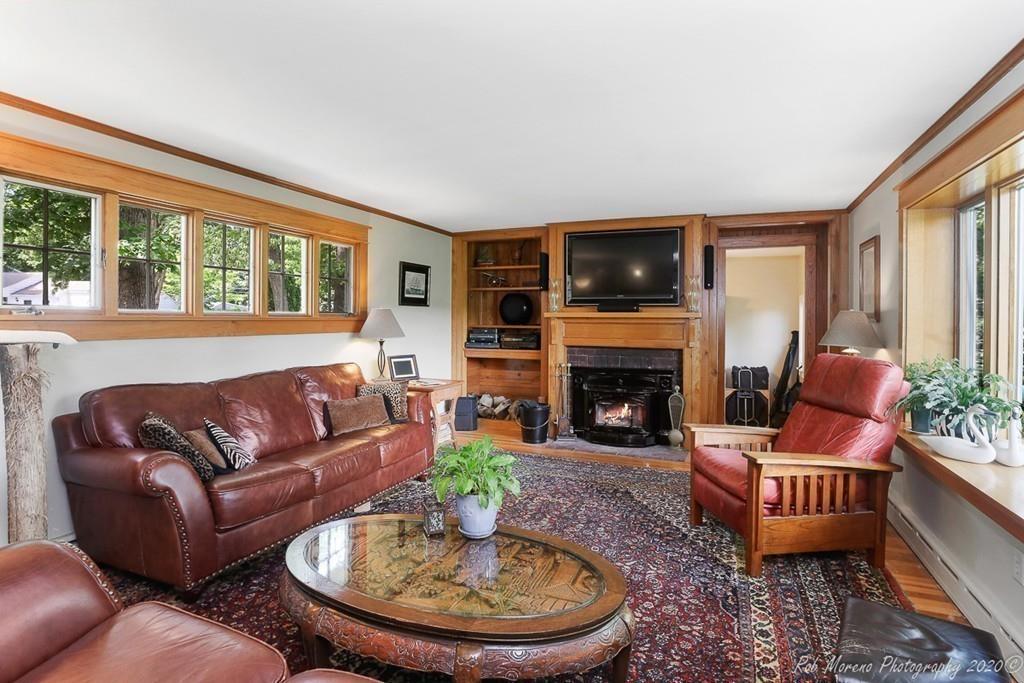 6 Pilgrim Road Hamilton, MA 01982 - Photo 9 of 32 a living room with furniture a flat screen tv and a fireplace