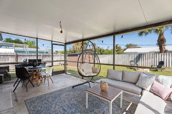 a living room with a couch a table and kitchen view