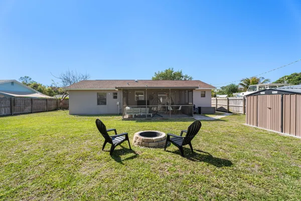 a swimming pool with outdoor seating and yard
