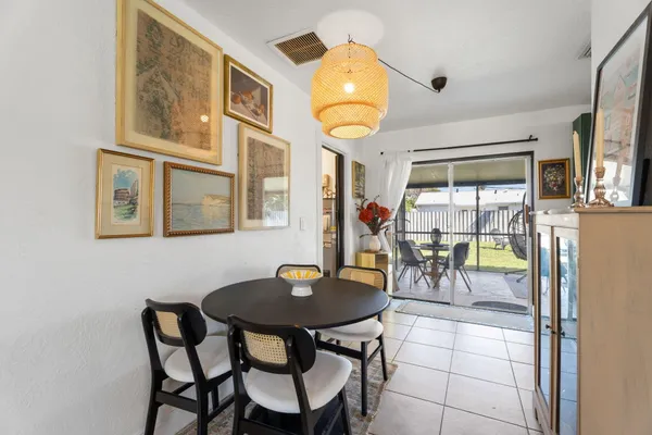 a view of a dining room with furniture and chandelier