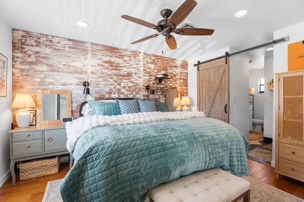 a bedroom with a bed a window and a chandelier