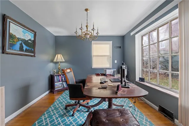 a view of a dining room with furniture window and wooden floor