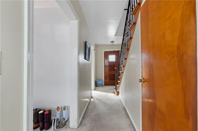 a view of a hallway with paintings on the wall