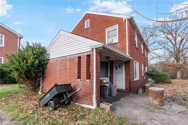 a view of a house with a yard and furniture