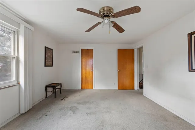 a view of room with a ceiling fan