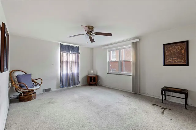 a view of a livingroom with workspace and a window