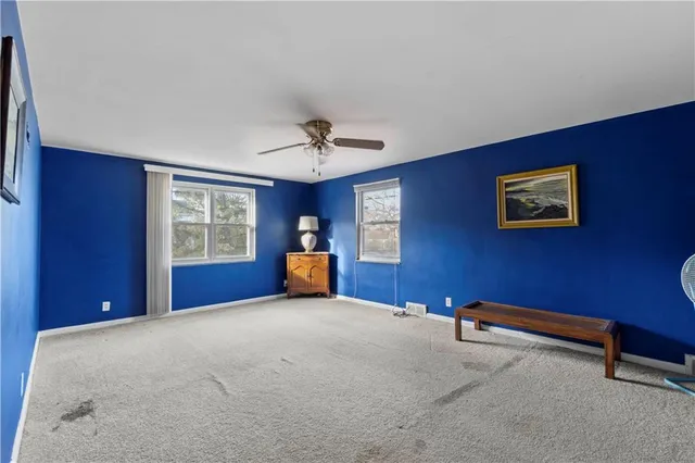 a bedroom with a bed and a table chair