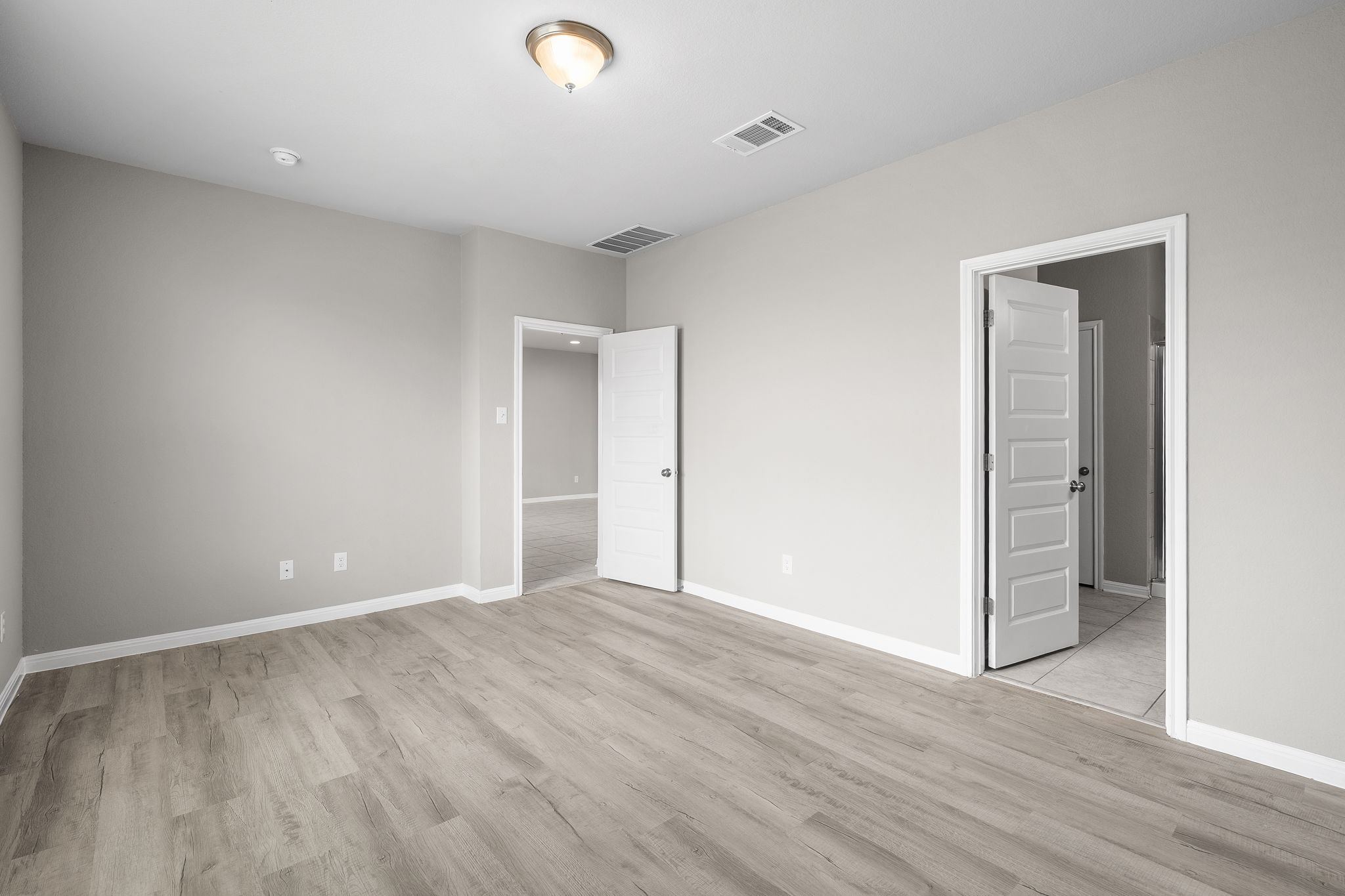 313 Mclintock Road Jarrell, TX 76537 - Photo 24 of 40 A well-lit bedroom features durable laminate flooring and crisp, neutral walls.