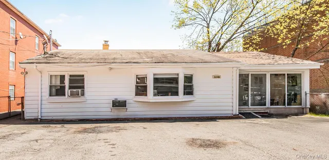 a view of a house with snow on the road