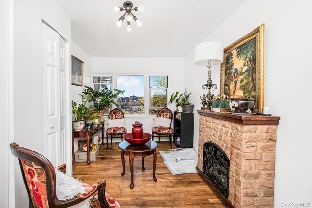 a living room with furniture a fireplace and a chandelier