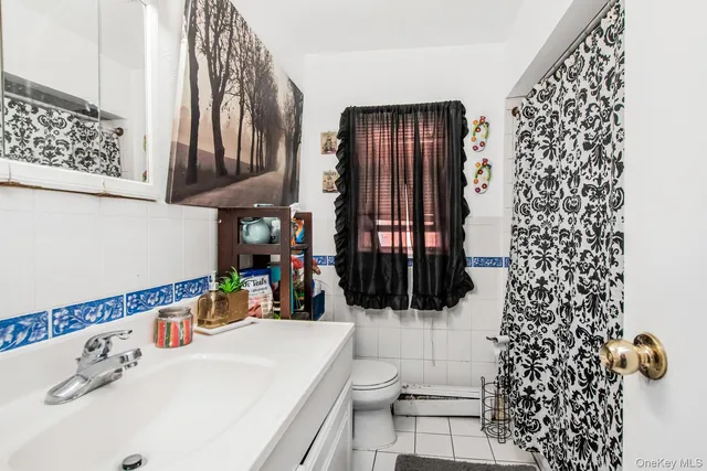 a living room filled with furniture and a potted plant