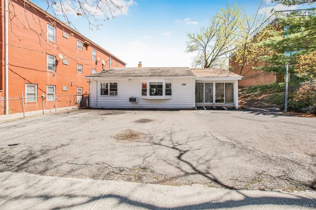 a view of a house with a yard covered in snow