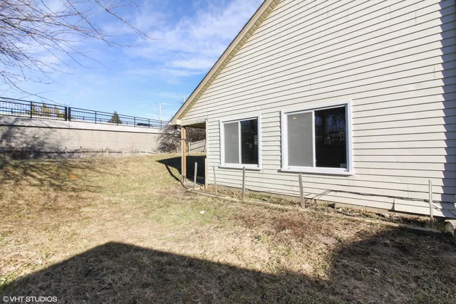 a view of house with backyard and space