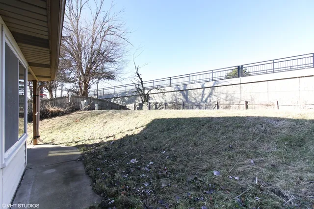 a view of a yard with snow on the road