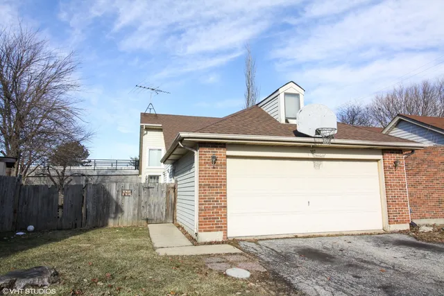 a view of a house with a wooden fence
