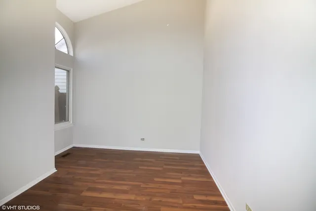 a view of a room with wooden floor and white walls
