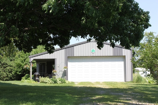 17530 Millard Road Morrison, IL 61270 - Photo 3 of 17 a front view of a house with a garden and yard
